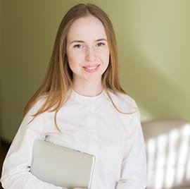 Maplewood educator holding a laptop