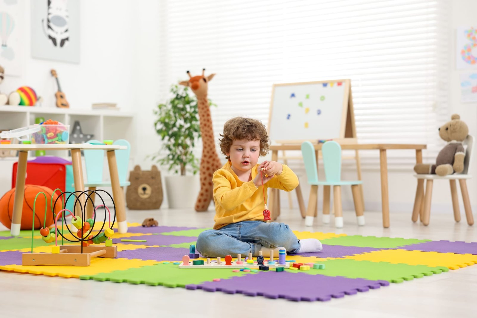 Child playing a numbers puzzle game in kindergarten