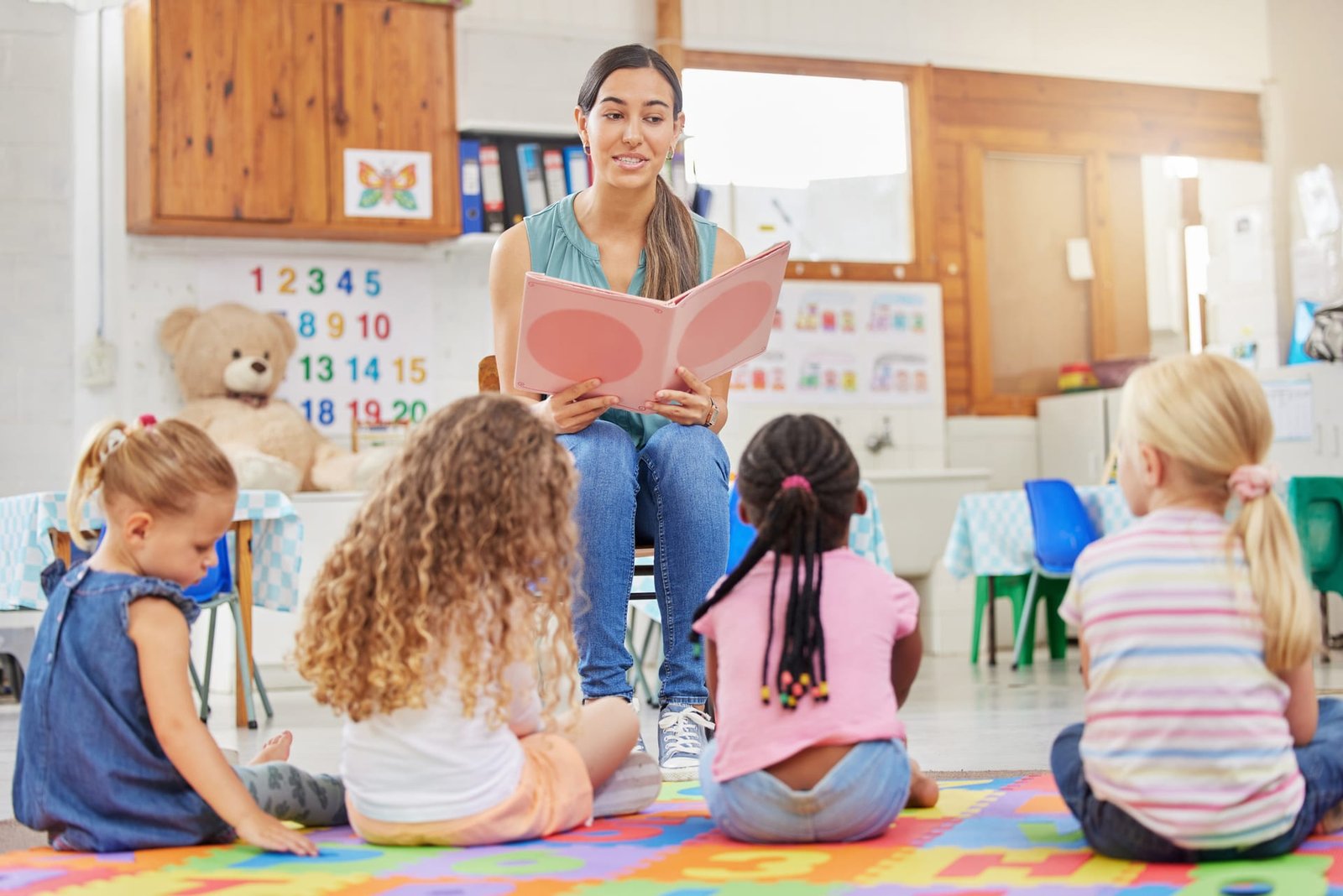 Teacher reading a story to kindergarten children
